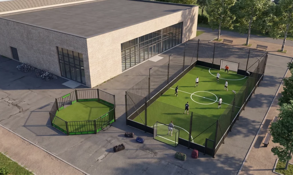 vue en hauteur d'un gymnase devant lequel sont installés un terrain de foot 5 avec des joueurs et une arène de foot panna